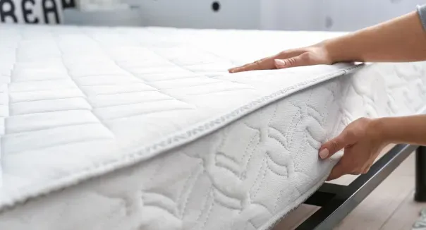 person flipping mattress